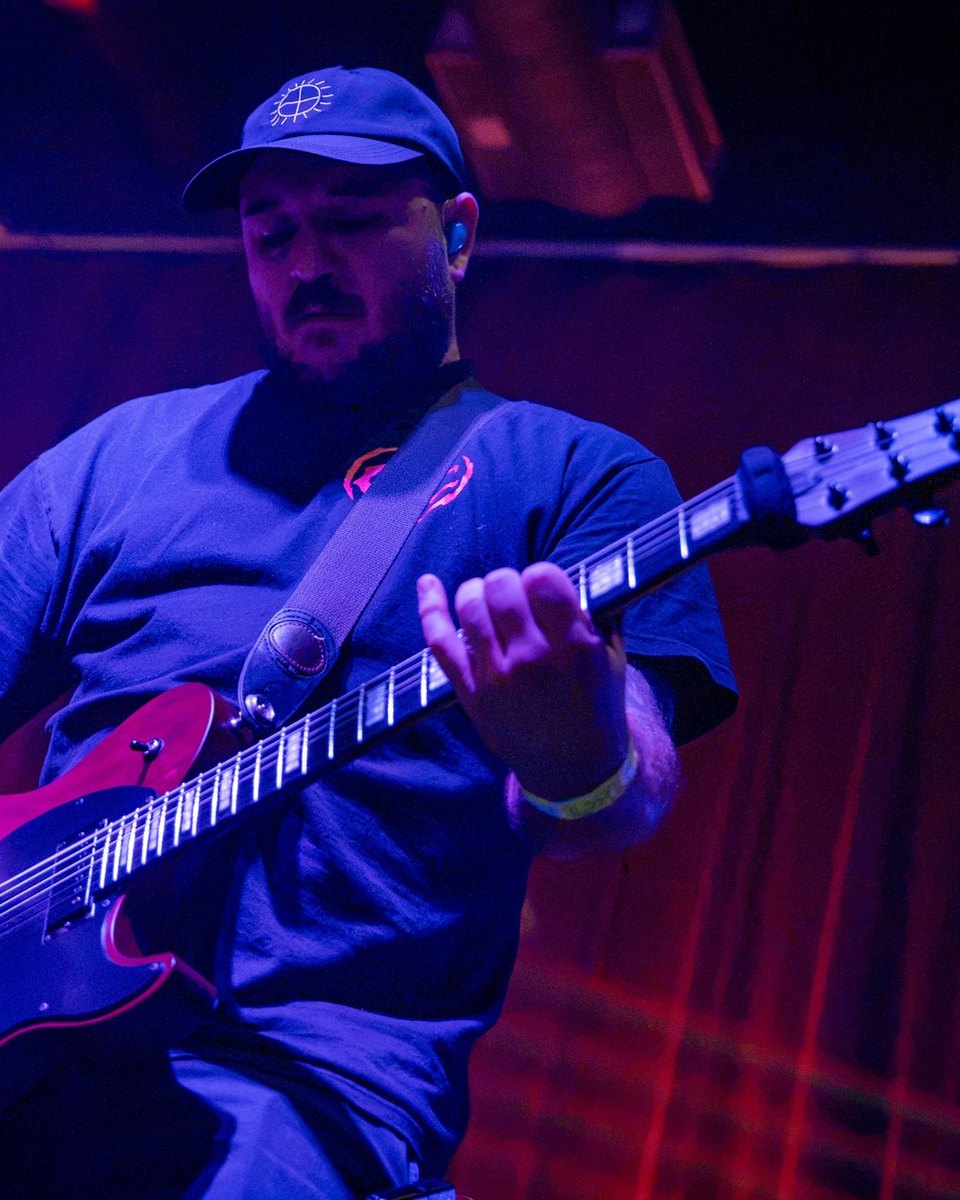 Paul on guitar in red and blue stage light